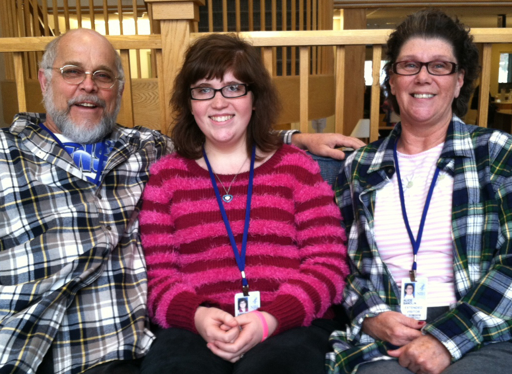 Girl with rare disease sitting with parents