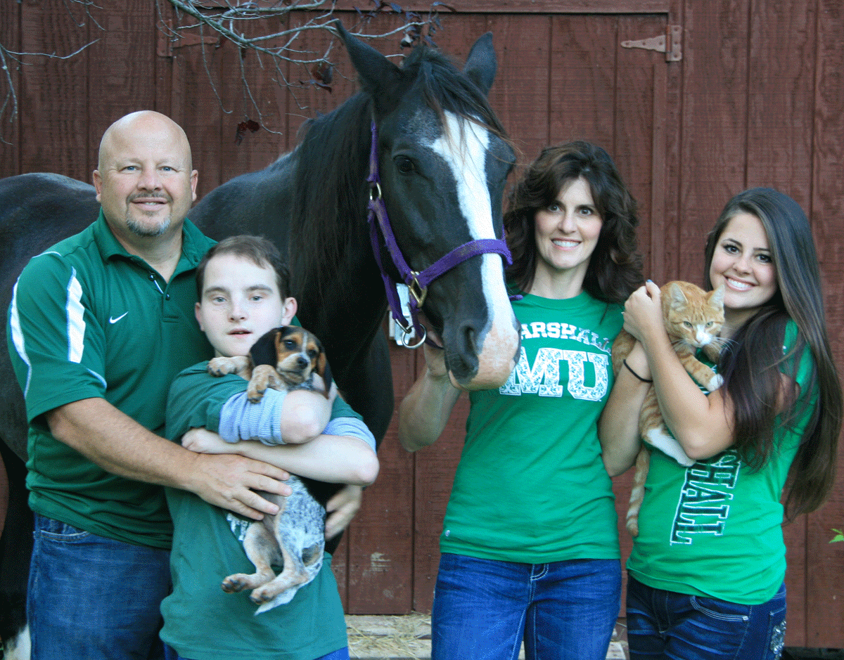 Zach Toppins family wearing green with Animals, horse, cat, and dog