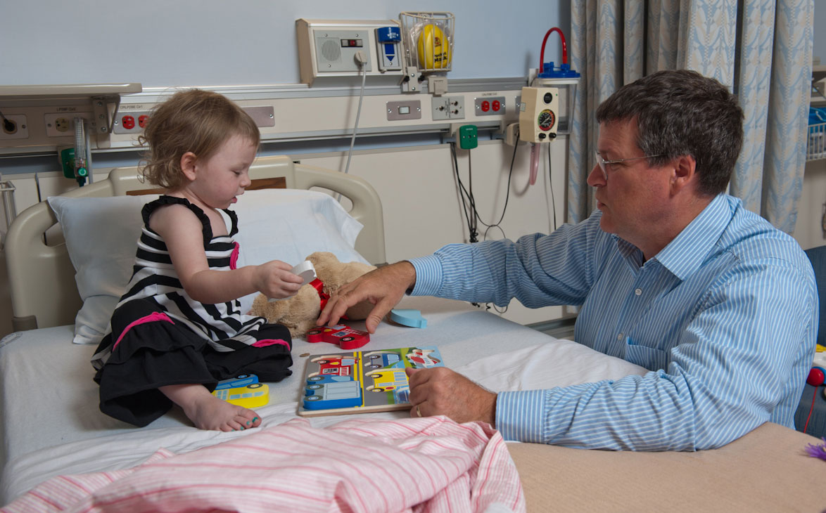 Kamryn a small baby in hospital bed next to a doctor