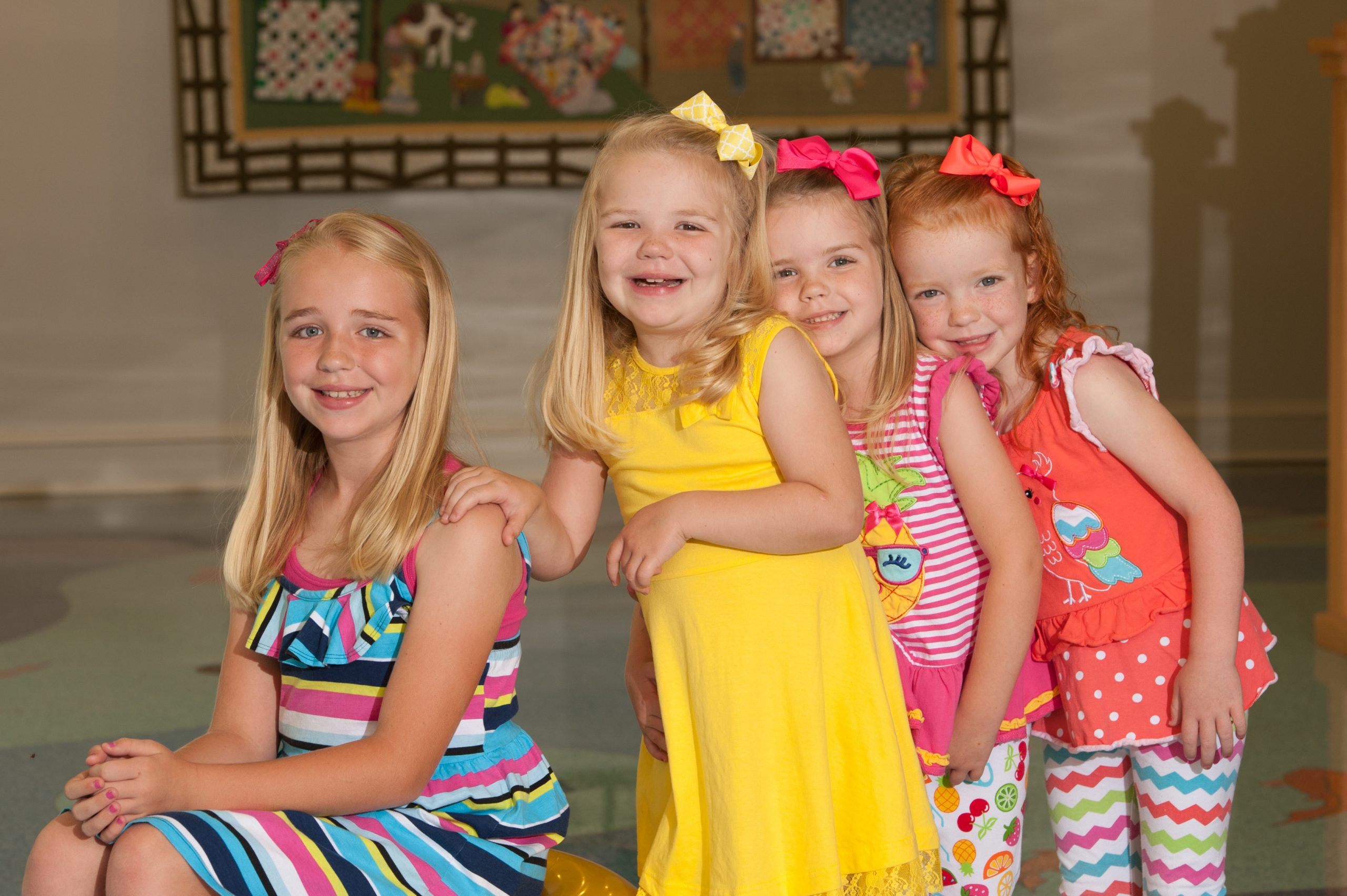 Olivia and her three sisters pose for a picture together at the Children