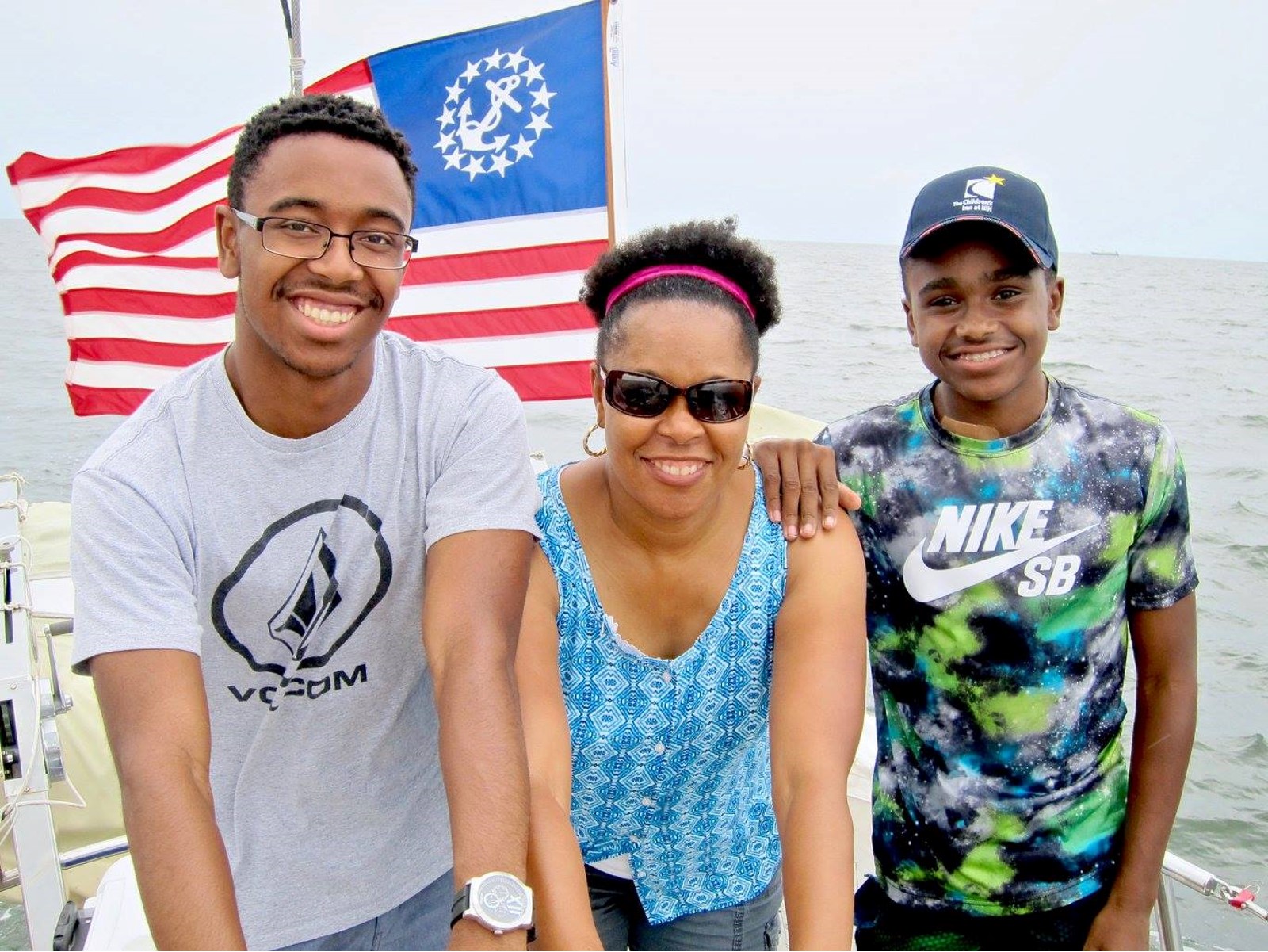 Aaron with his mother and Father and their countries flag