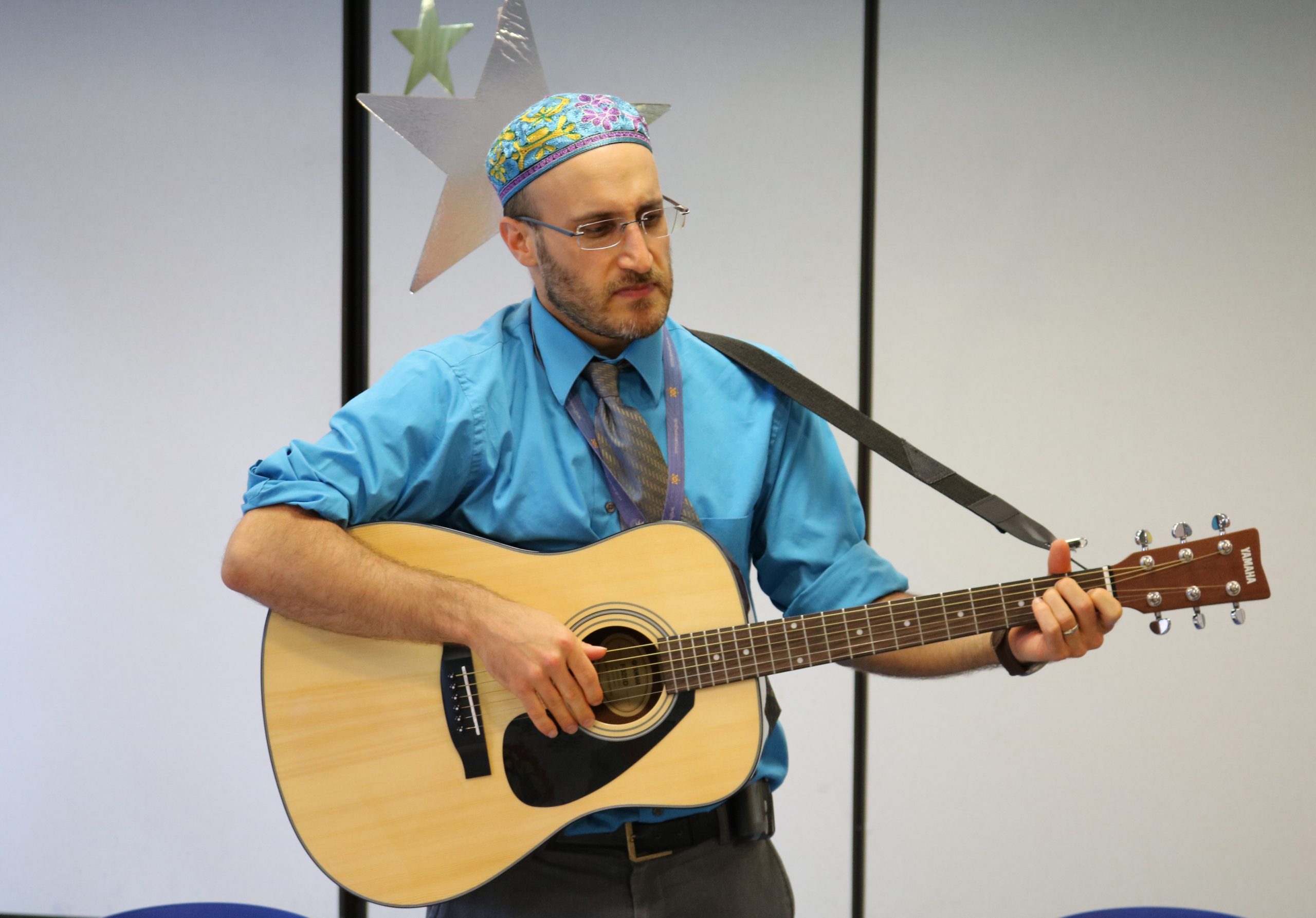 Chaplain Mike is playing his acoustic guitar