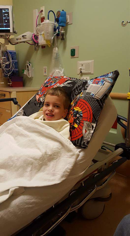 Mitochondrial myopathy child lays in hospital bed