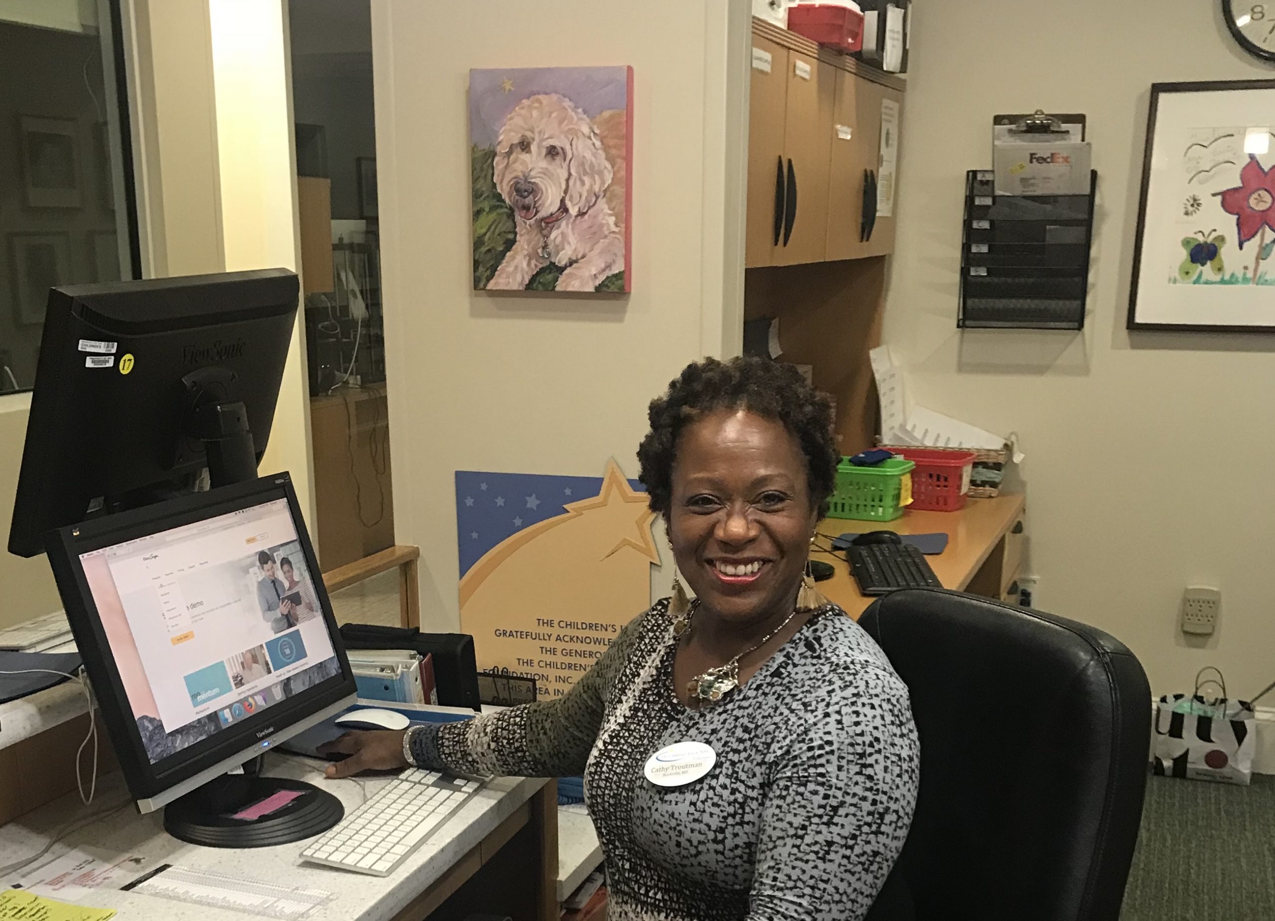 Cathy Troutman at volunteer desk of The Children