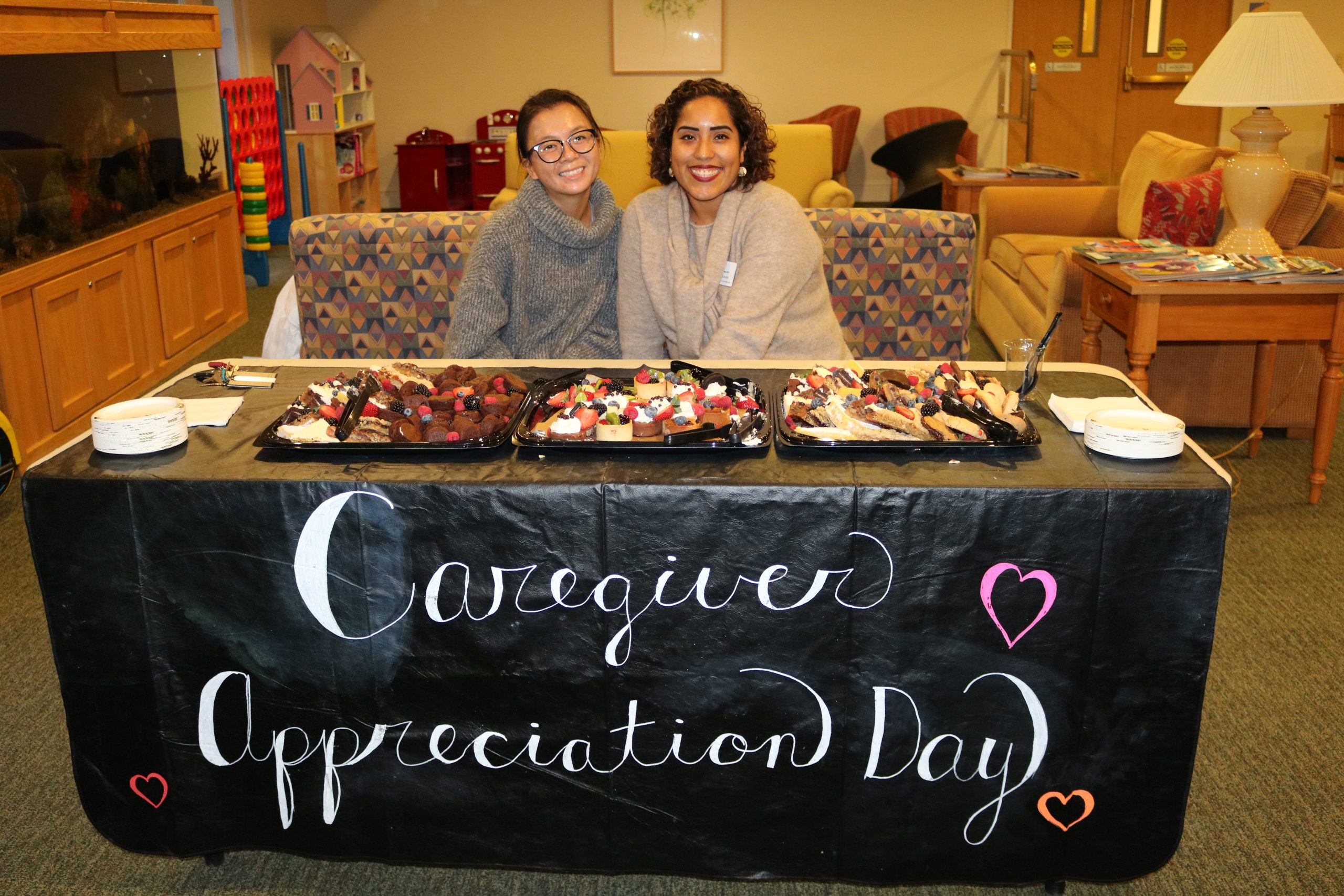 Two women at Caregiver Appreciation desk