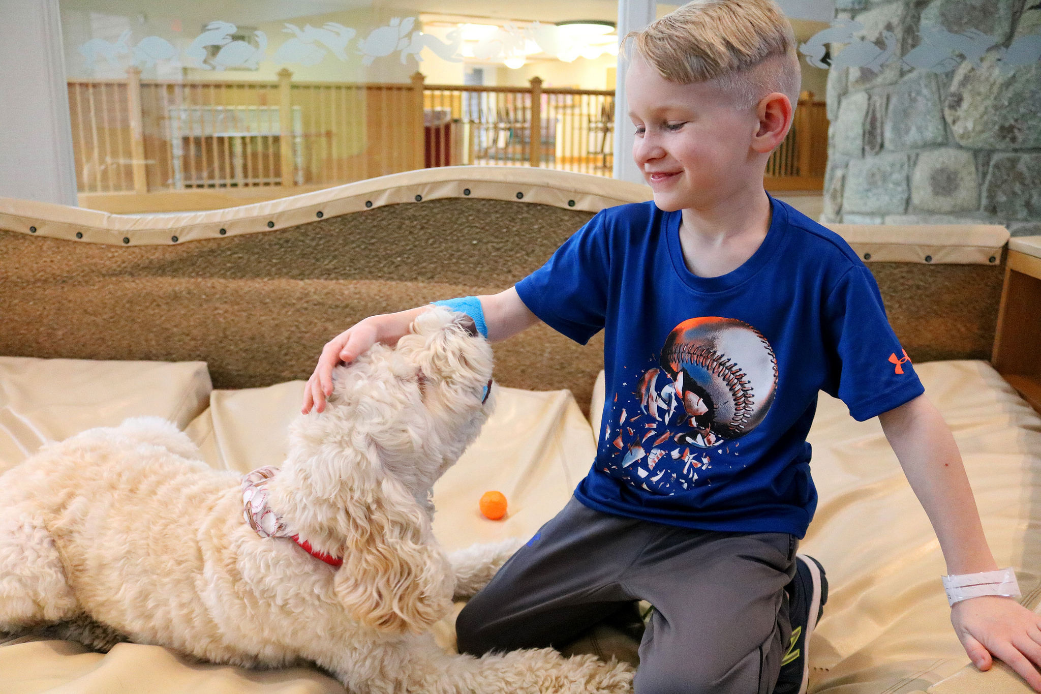 Abram a young boy and Zilly the therapy dog