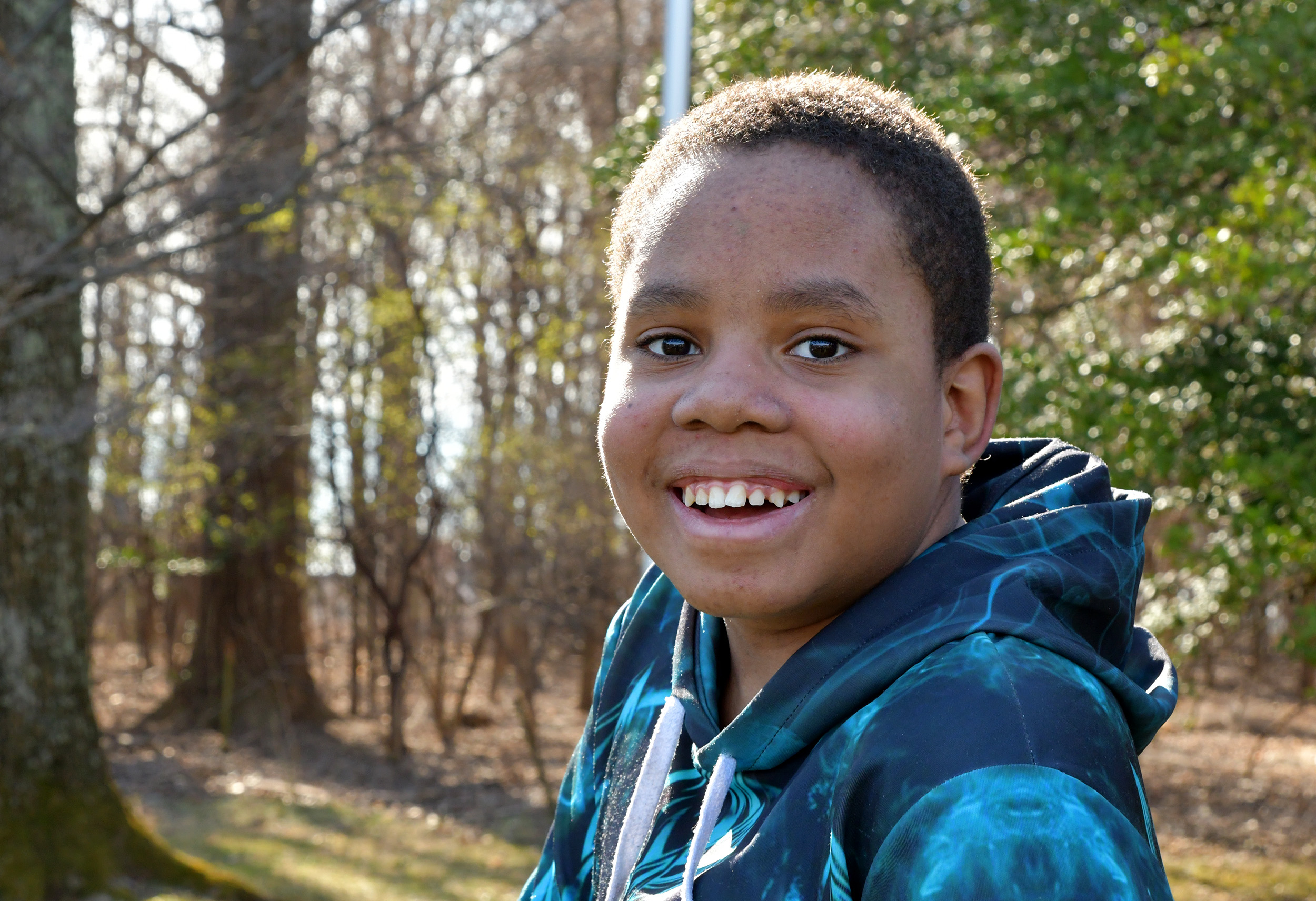 boy smiling in the forrest