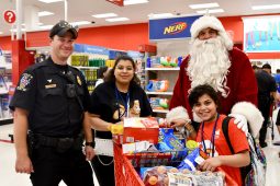 Santa with a cop and a family shopping for christmas in the summer
