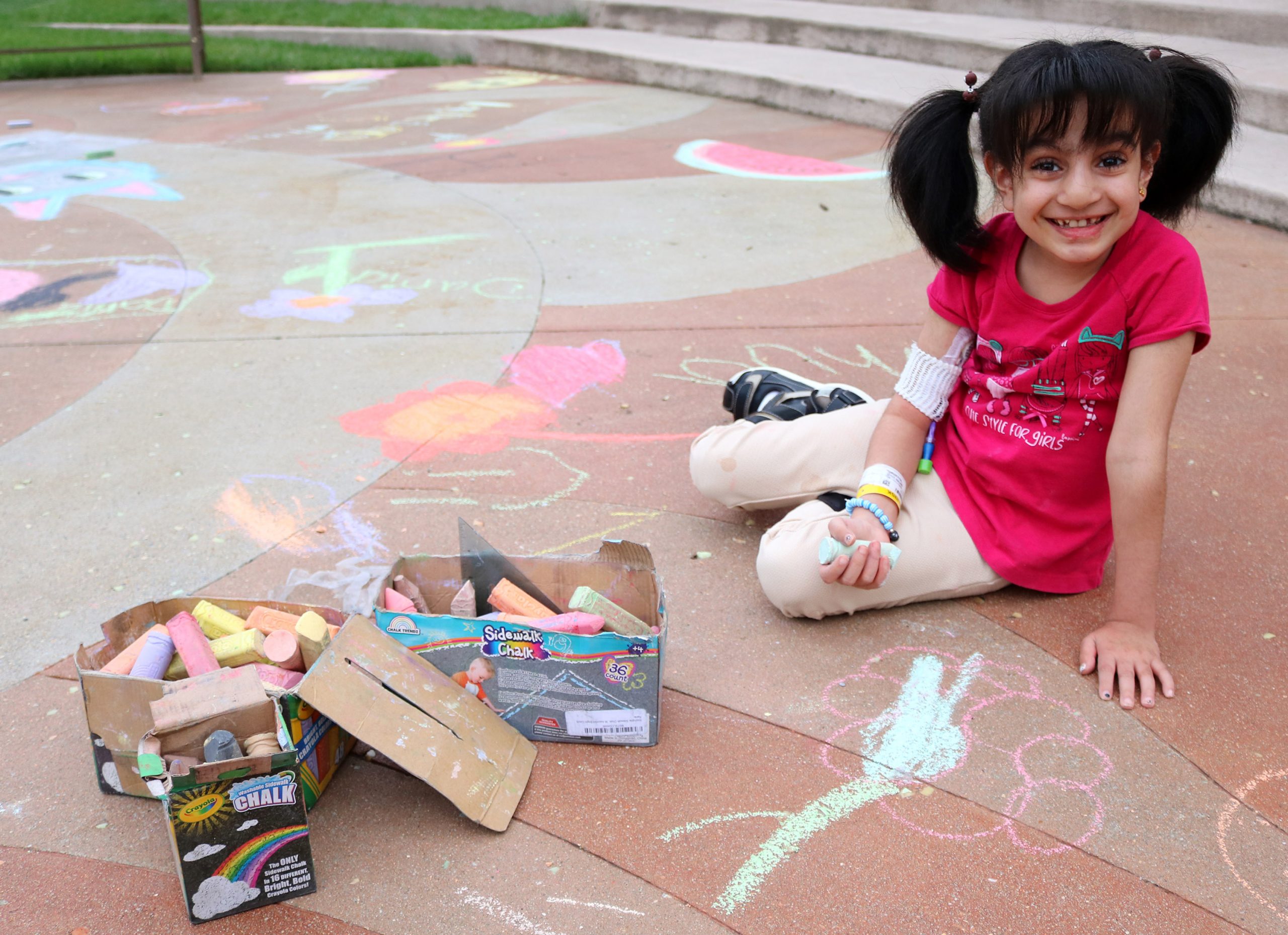 Muna creates chalk art outside