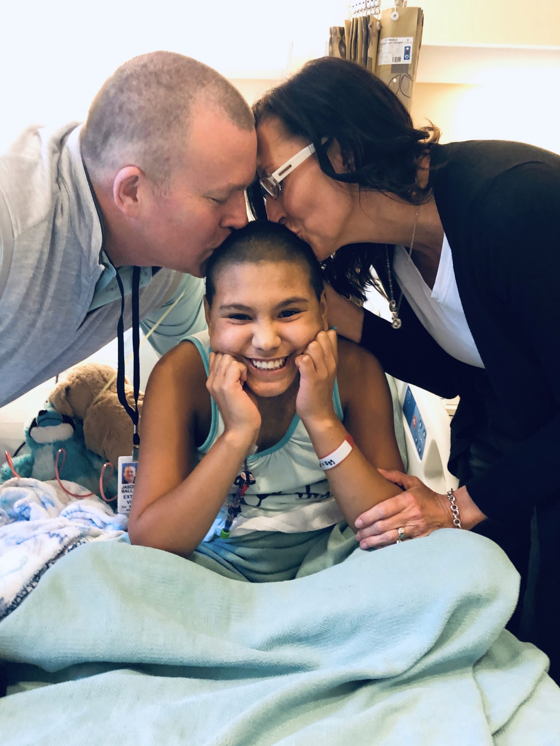 Emi in the hospital with her parents