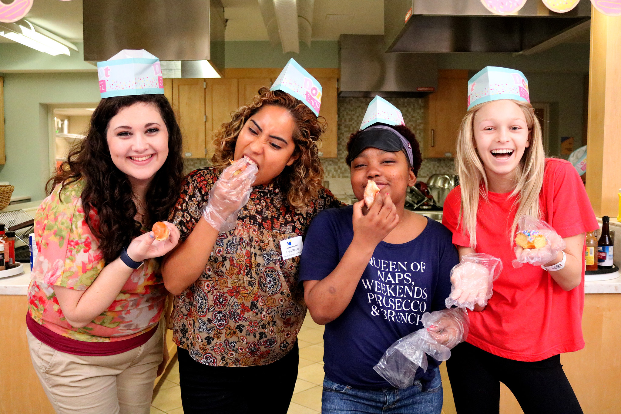 Residents Danielle and Parys with Inn staff members at an Inn donut-themed party