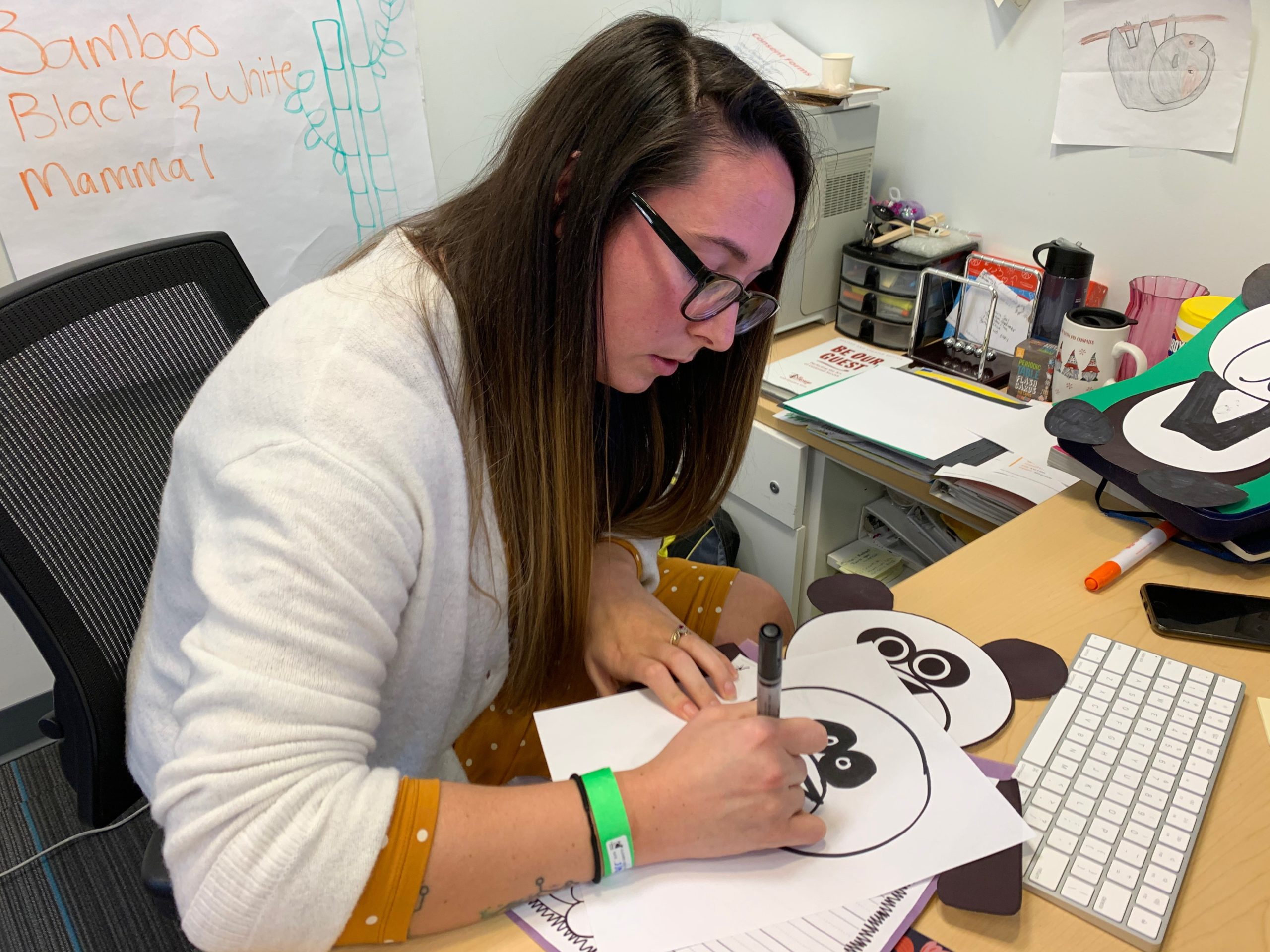 Doctor writing notes at her desk