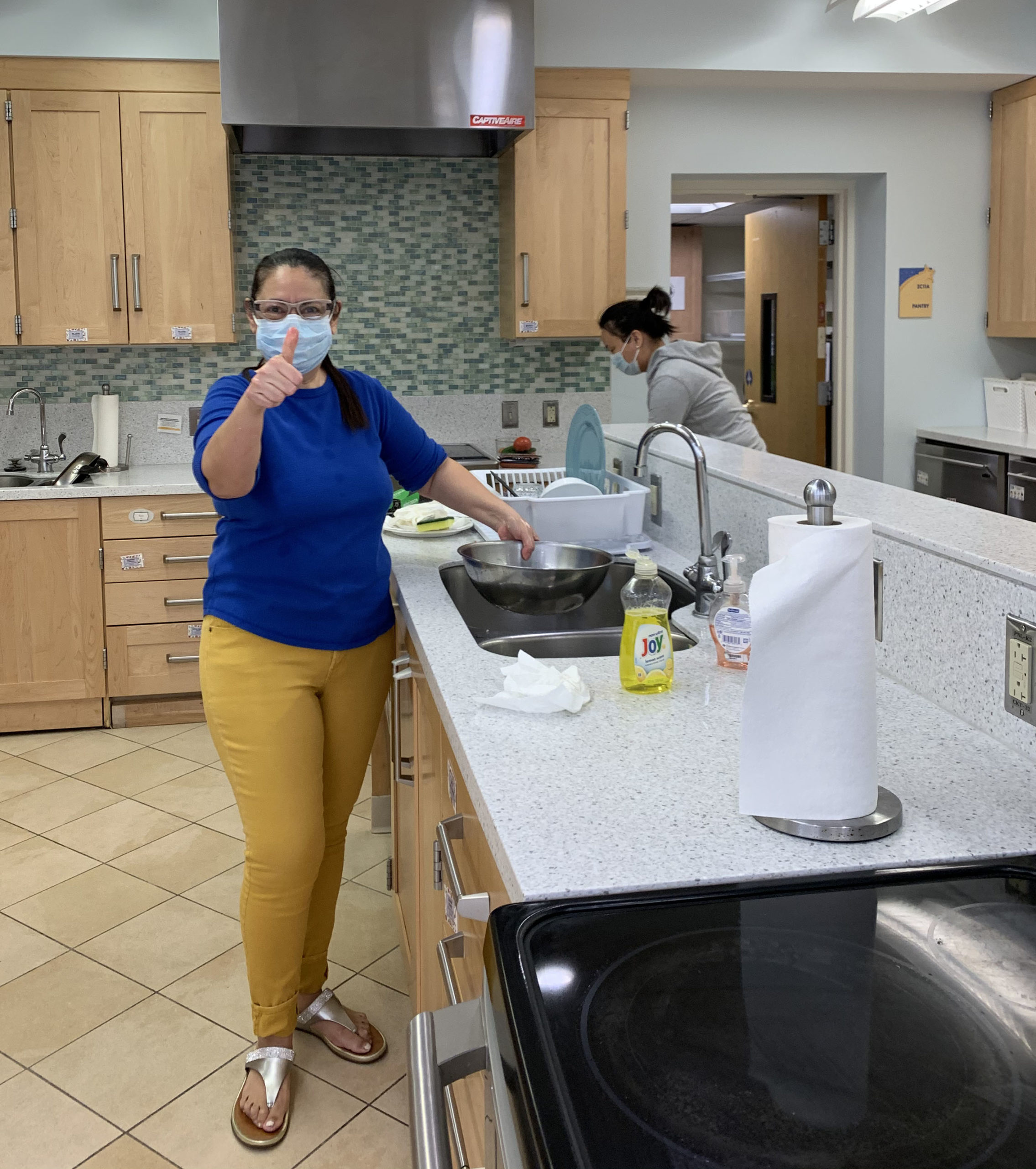 woman wearing a face mask cleaning at the Inn