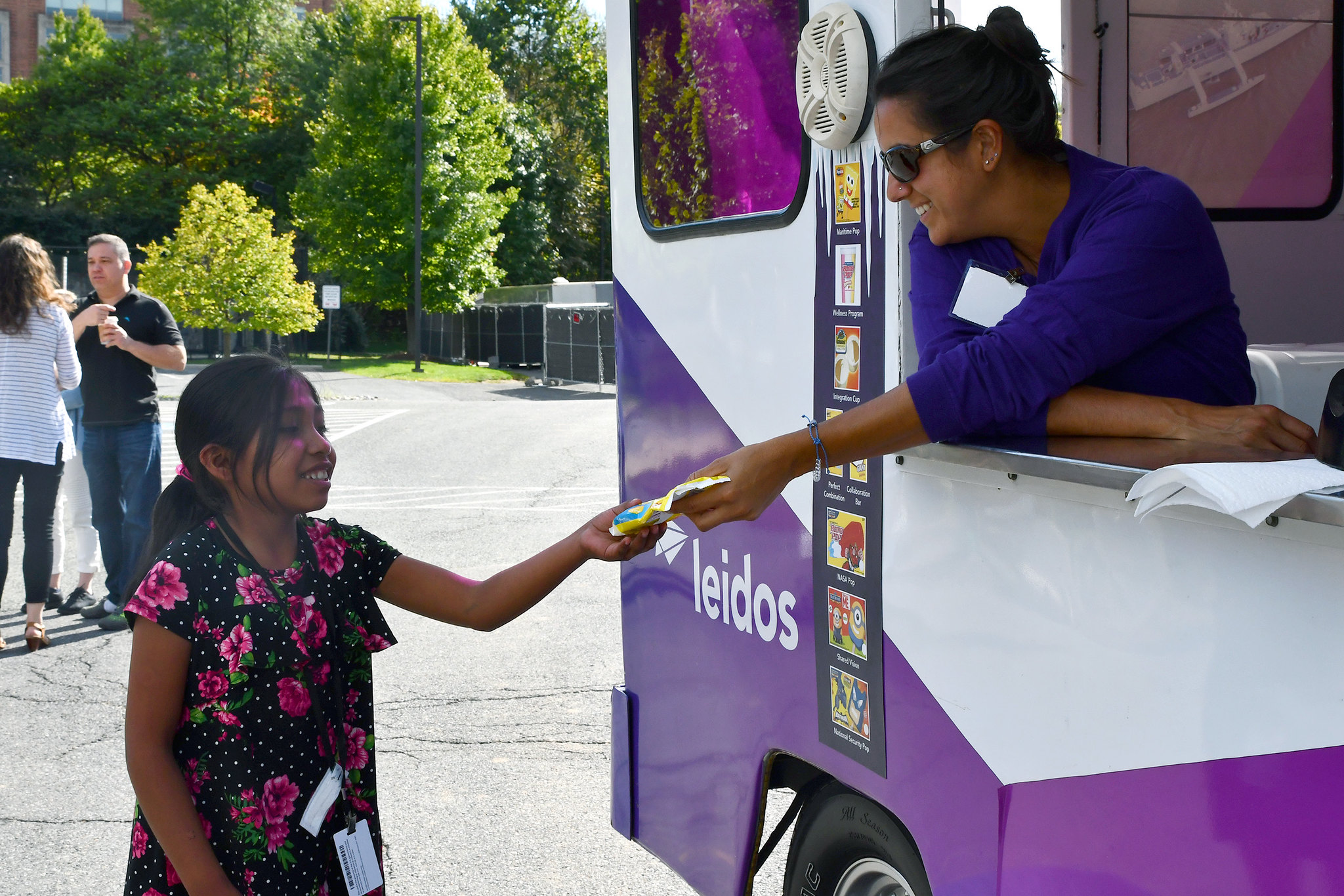 Girl buying ice cream from Leidos ice cream truck