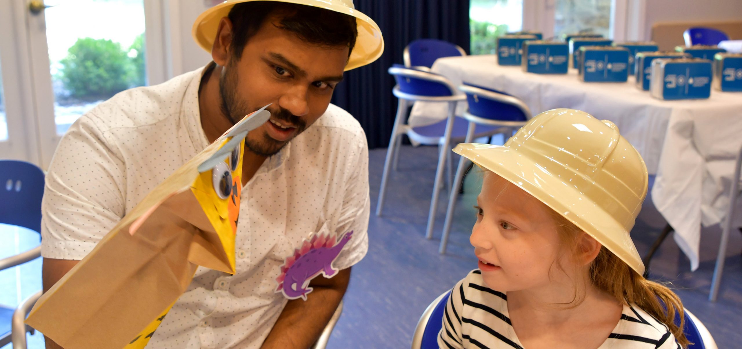 Man entertaining a child with hand puppet