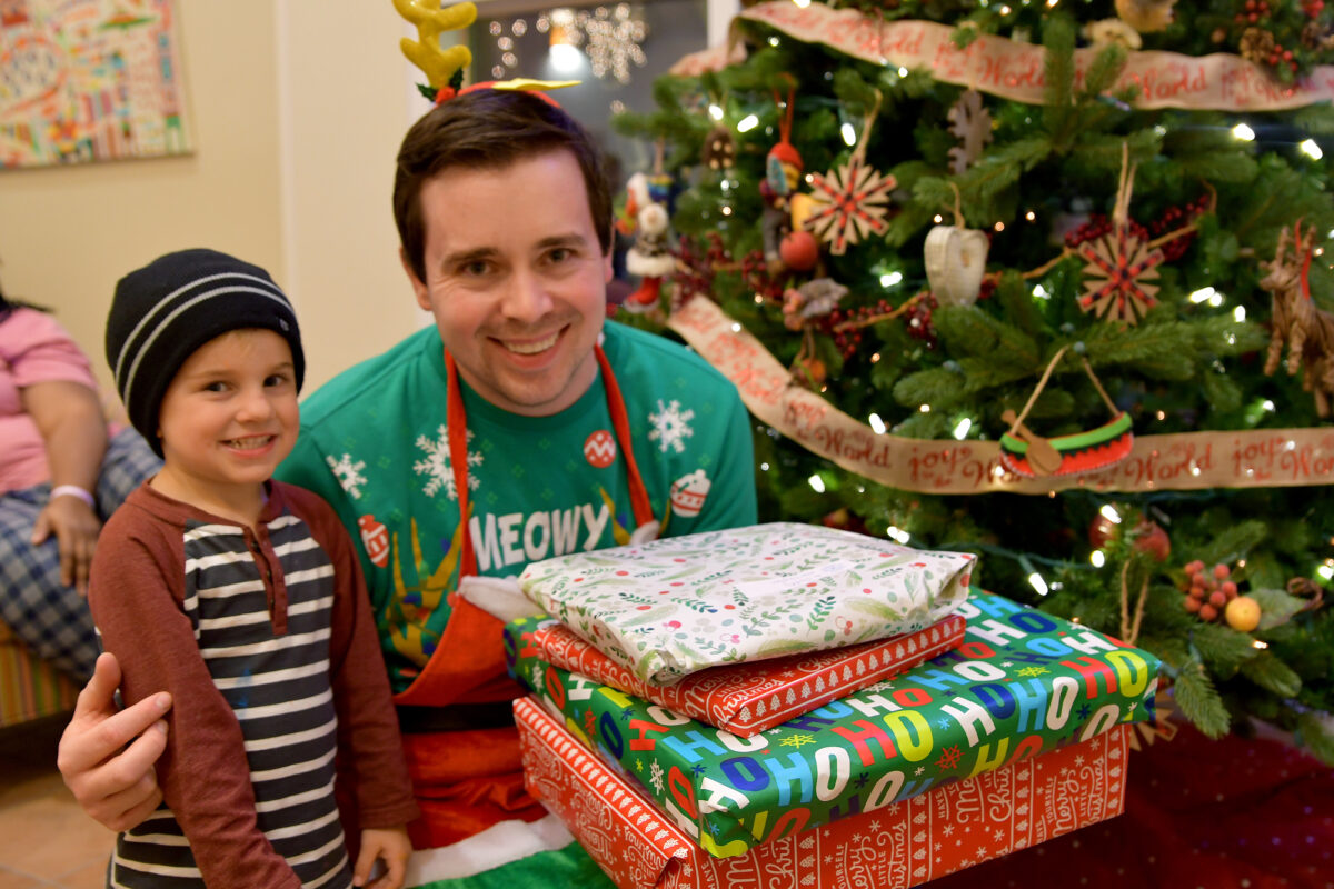 receiving gifts by a Christmas tree