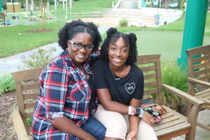 Faithanne and Mom sitting together on a park bench