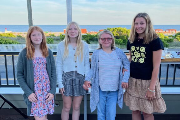 Marijka with three friends smiling.