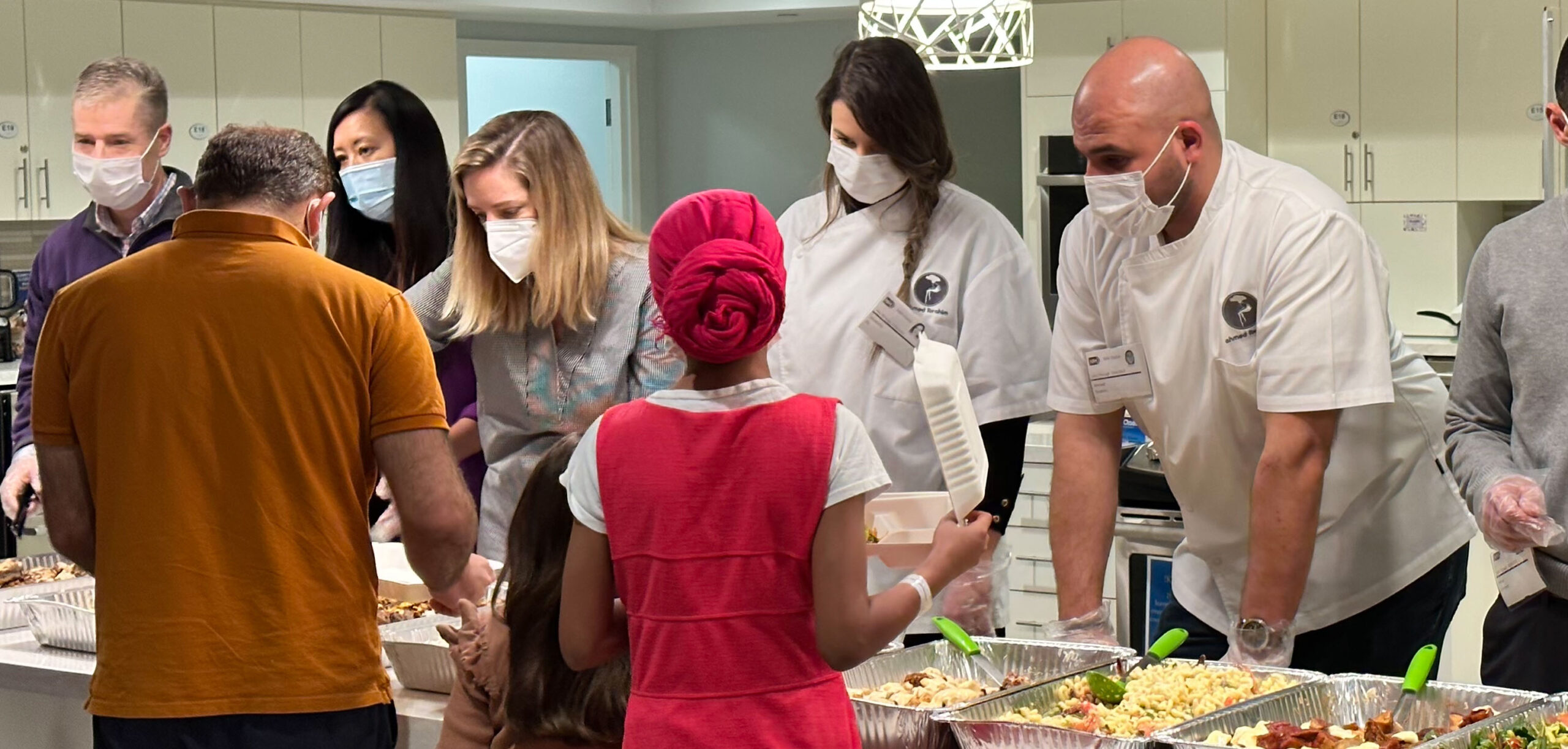 Volunteers serving dinner to residents