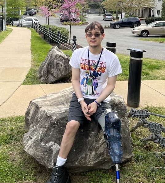 Charlie sitting on rock