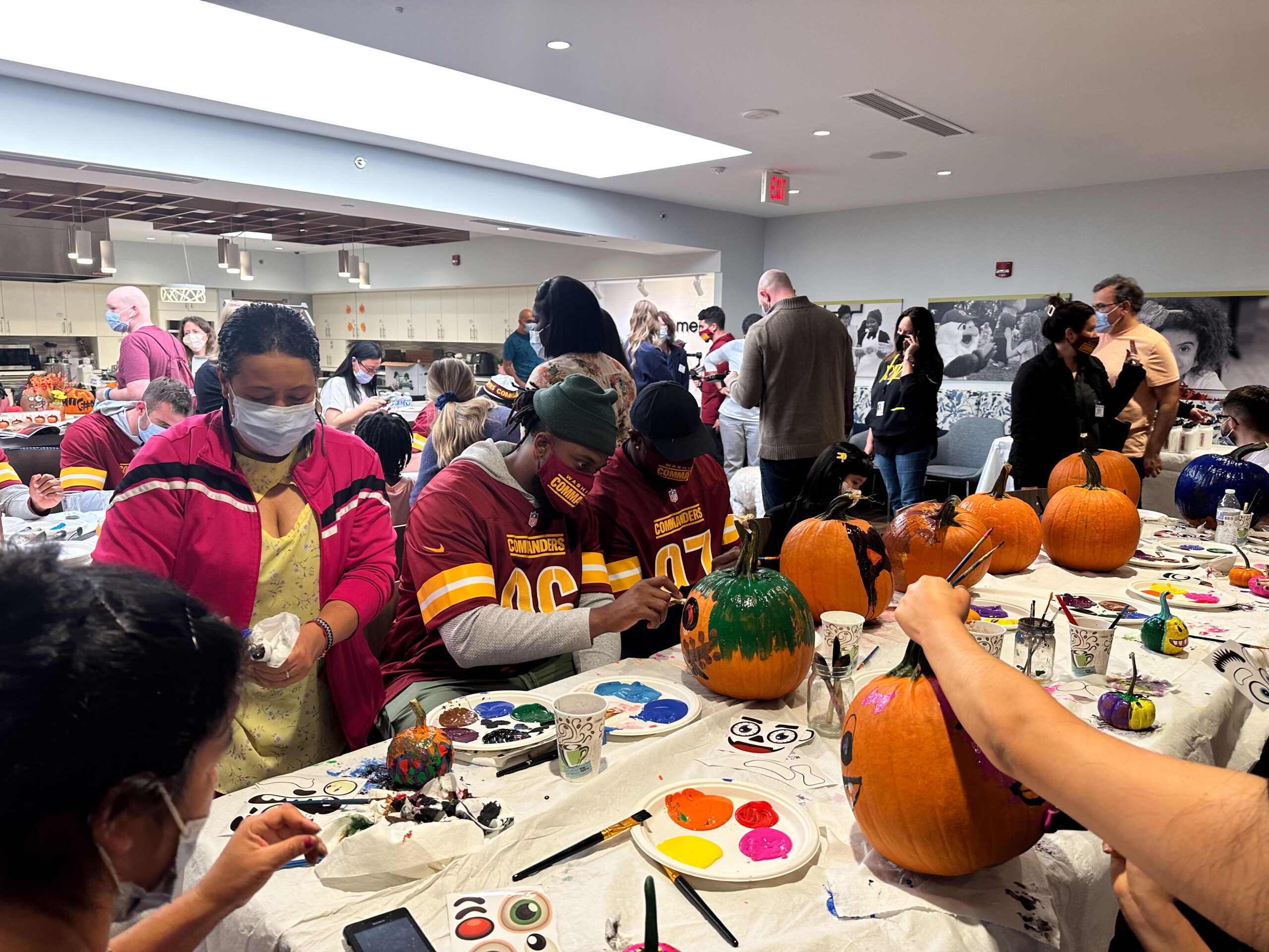 Washington Commanders painting pumpkins