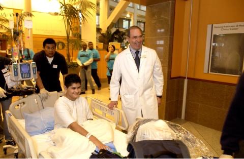 In 2005, then-Clinical Center director Gallin (r) greets Marcos Arrieta of El Paso, Tex., NIH Record 